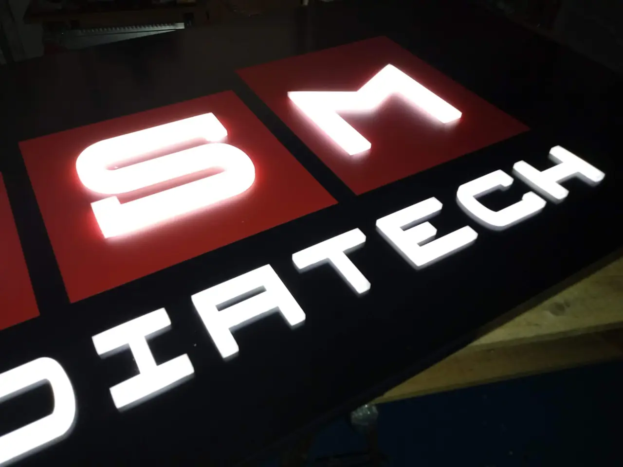 Letras corpóreas retroiluminadas en rojo y blanco